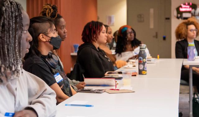 Women listening to a speaker at a CRWN event