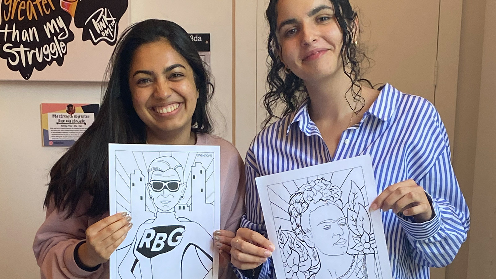 Women holding up artwork