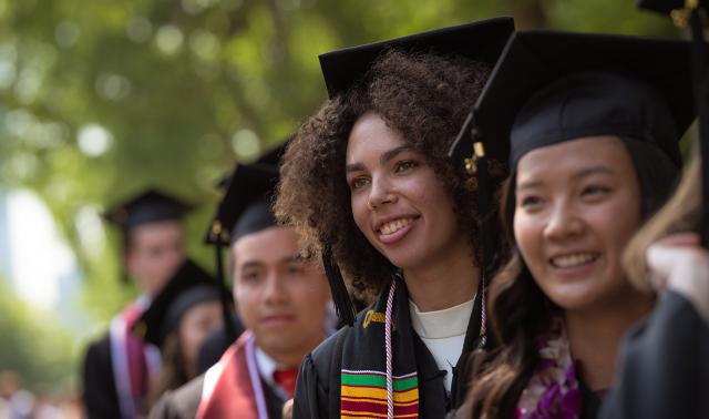 Women in graduation gowns attending commencement